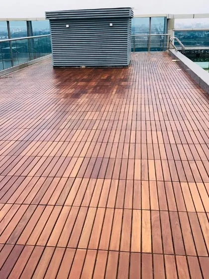 Another perspective of the rooftop deck, showing how the linear pattern of the IPE wood planks creates a sense of depth and space.