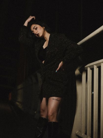 A thoughtful, looking-down pose that adds a touch of vulnerability to the strong look.