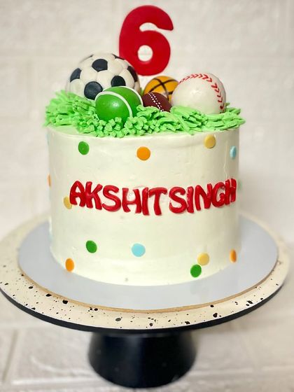 A full view of the multi-sport themed cake, perfect for a 6th birthday.