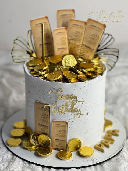 Who needs gold bars when you can have a gold cake? This fun, customized cake is overflowing with edible gold coins and bars.