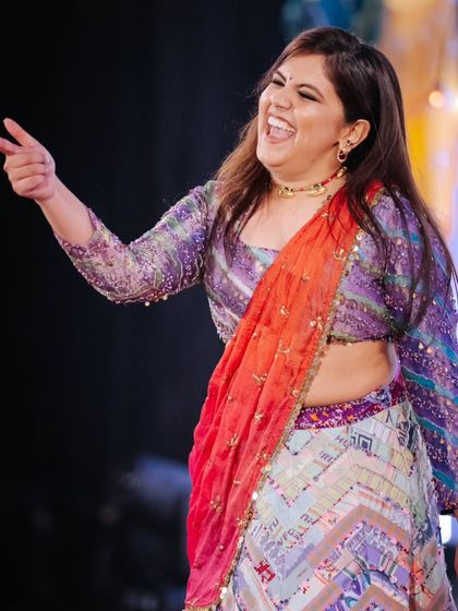 A candid shot of our choreographer enjoying the sangeet night, full of laughter and joy.