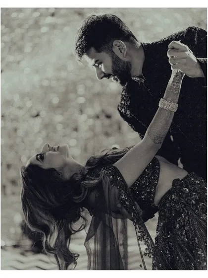 A classic dance pose captured in timeless black and white. This shot from their sangeet night is full of romance and movement.