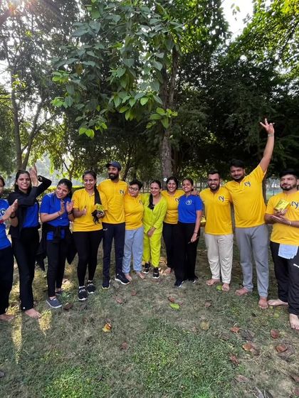 A team photo from our yogic picnic. The bright yellow shirts and even brighter smiles show the vibrant energy of our studio family.