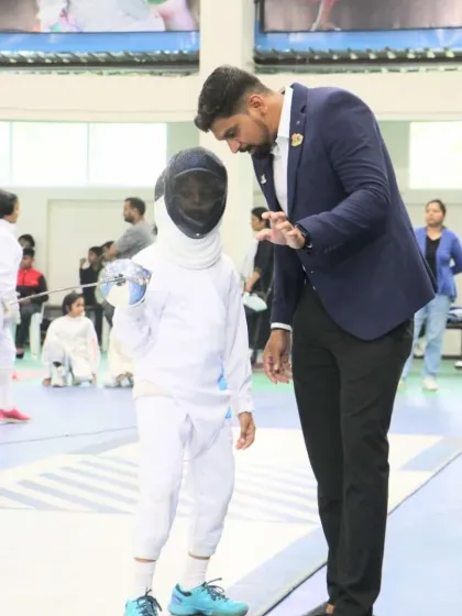 Mentorship is at the heart of what we do. Here, I am providing one on one guidance to a young fencer, helping her refine her stance and grip. We believe every champion starts with a coach who believes in them.