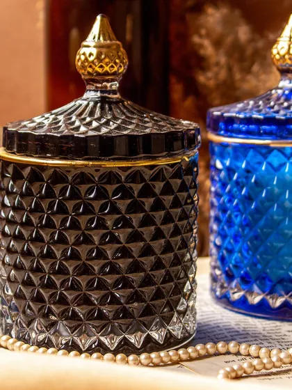 My golden line crystal jar soy candles are designed to add a touch of luxury to your home. This shot shows the elegant black and royal blue jars, which can be filled with any custom fragrance you choose, from cozy Oud to fresh Lily Rose.