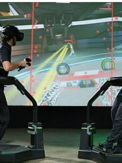 This image captures the dynamic action of a multiplayer VR game, where players physically move to control their characters and compete against each other.
