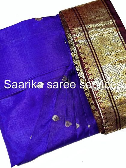 A royal blue saree with a rich border, pleated and ready. My service takes the stress out of getting ready.