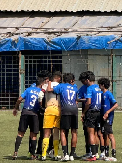 The team comes together in a tight huddle, showing their unity.