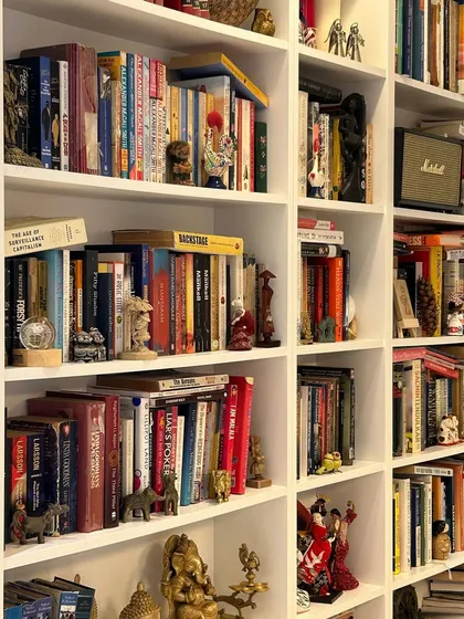 Our membrane-finished bookshelves provide a clean and timeless backdrop for a personal collection. Here, the simple white structure allows the owner's books and antiques to become the true focal point, turning a storage unit into a gallery of personal treasures.