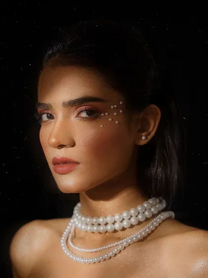 A striking beauty portrait using dramatic shadow and light. This close-up highlights the delicate pearl makeup details, demonstrating my skill in creative lighting for beauty and editorial work.
