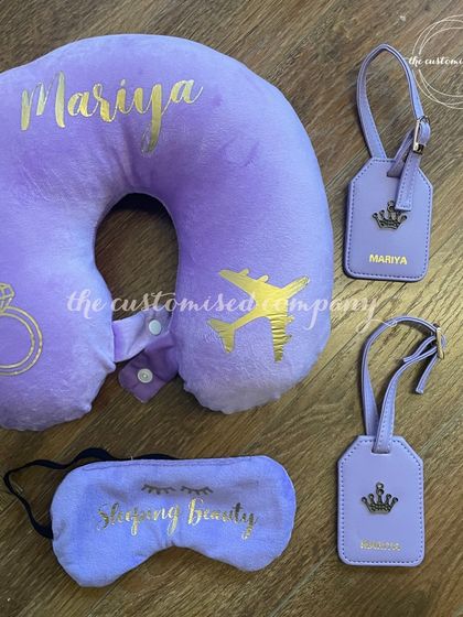 Get your bride tribe ready for a getaway with this personalized travel set in a lovely lavender shade. It includes a "Sleeping Beauty" eye mask, a custom neck pillow, and matching luggage tags.