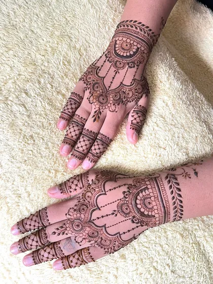 A different angle of the elegant guest mehndi, showing how the patterns on both hands complement each other.