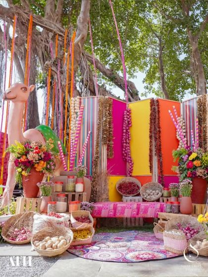 A truly unique mehendi setup inspired by a Rajasthani bazaar. The vibrant colors, camel prop, and rustic elements like spice jars and baskets create an immersive and unforgettable cultural experience.
