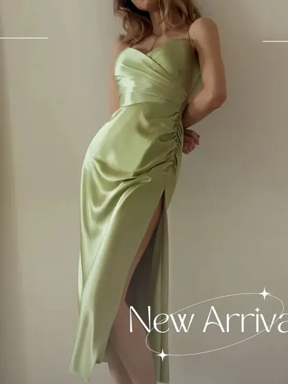 A side profile of the Verdant dress, emphasizing the high slit and the elegant drape of the satin.