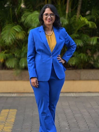 A photo of me in a blue suit. My mom taught me a life-changing lesson: the real competition is with yourself, not others. This mantra helped me score 100% in PCM and drives me to give my 100% in everything I do.