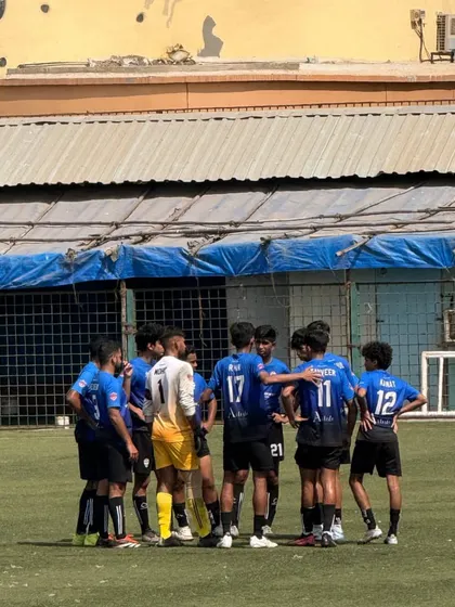 A pre-game huddle with the coach, getting final instructions before a First Division match.