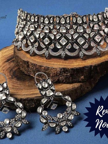 This bold, wide choker is made with uncut polki stones set in a dark metal finish, giving it a modern yet rustic charm. It's a statement piece for any occasion.