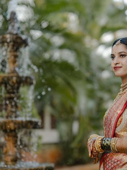 My beautiful client-turned-family, Chethana, looks timeless in this white and pink Kanchipuram saree. I designed a heavily handcrafted bridal blouse with intricate zardozi work to complement the saree's elegance for her special day.