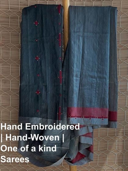 A one-of-a-kind hand-embroidered and handwoven saree. This grey and red piece is part of our exclusive range where each saree is different and completely unique, just like you.