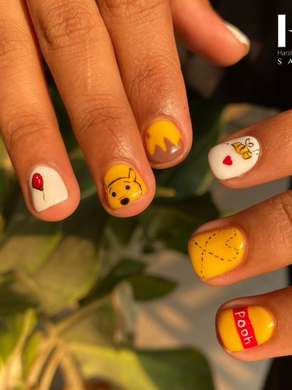 Bring your favorite characters to life on your fingertips. This adorable set is inspired by Winnie the Pooh, with each nail featuring a different hand-painted element, from Pooh himself to a honey pot and a buzzing bee.