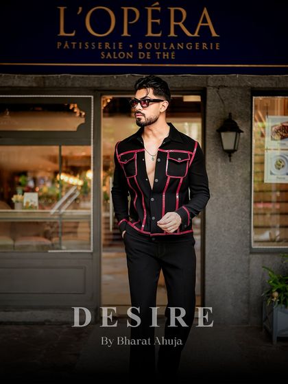Another full-length view of the black and red piped jacket, a piece that is both bold and timelessly cool.