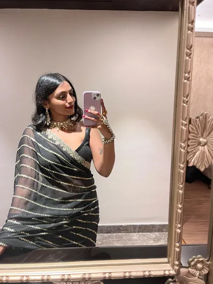 Playing with angles in the mirror. This shot shows how the light catches the metallic stripes on the saree, adding a subtle shimmer to the look.