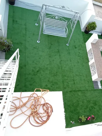 A top-down look at the terrace installation, highlighting the consistent green look of the artificial turf across the entire area.