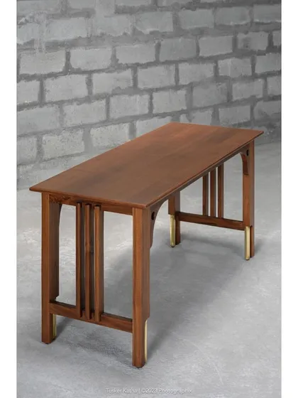 Introducing the Madhu Study Table, a statement of discerning aesthetics and master craftsmanship. The harmonious blend of solid teak and brass accents makes it a versatile addition to any interior style.