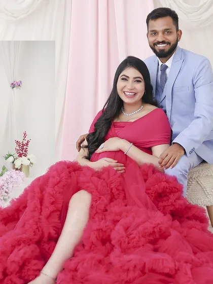 A joyful portrait of the happy couple, seated together in our studio. Their bright smiles reflect the happiness of this special time, creating a perfect keepsake.