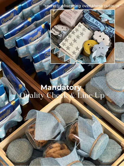 A mandatory quality check before anything goes out. I'm inspecting the treats and the custom celestial-themed cutouts for the 'It's a Boy' announcement hampers.