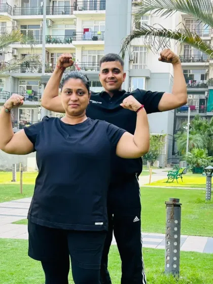Training is for everyone. Here I am with a female client, both of us showing the strength we've built.