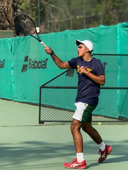 A player demonstrates perfect form and follow-through on a backhand during a practice session, a result of our detailed technical coaching.