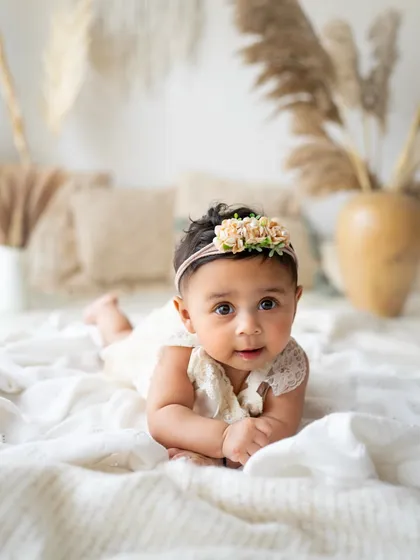 A beautiful portrait of a 6-month-old baby girl on a soft, neutral setup. My studio is designed to be a comfortable and calming space for these little ones.