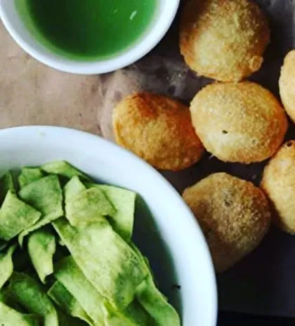A complete pani puri set, featuring my crispy golgappe and a bowl of green, spicy water. I also serve them with healthy roasted snacks for extra crunch.