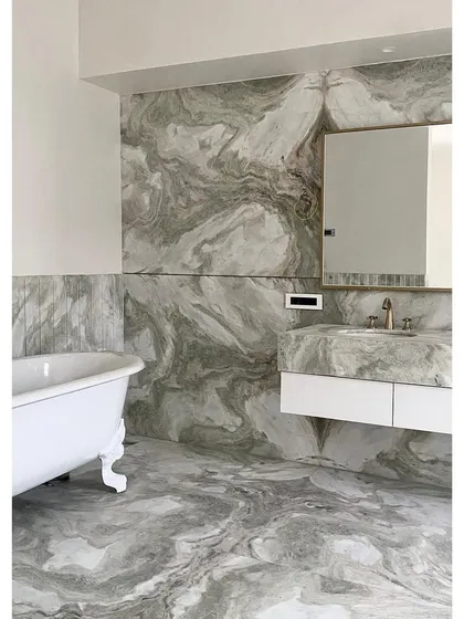 In this bathroom for 'Bungalow No 4', we used book-matched marble slabs to wrap the walls and floor. This technique creates a continuous, flowing pattern, turning the entire room into a luxurious and immersive art piece.