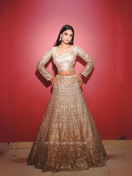 A classic portrait pose in our golden lehenga.