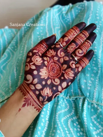 The dark, mature stain of the cutwork lotus design, showing the beautiful contrast against the skin.