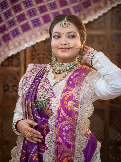 A beautiful portrait that highlights the traditional jewelry and the elegant drape of the saree.