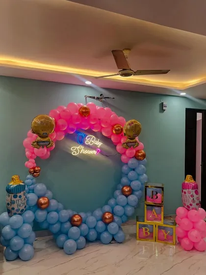 The full view of the pink and blue baby shower setup, complete with 'BABY' blocks.
