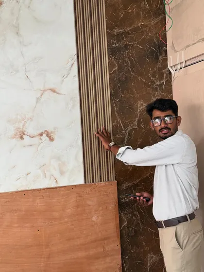 Showing off the combination of marble-finish and fluted panels being installed on a feature wall.