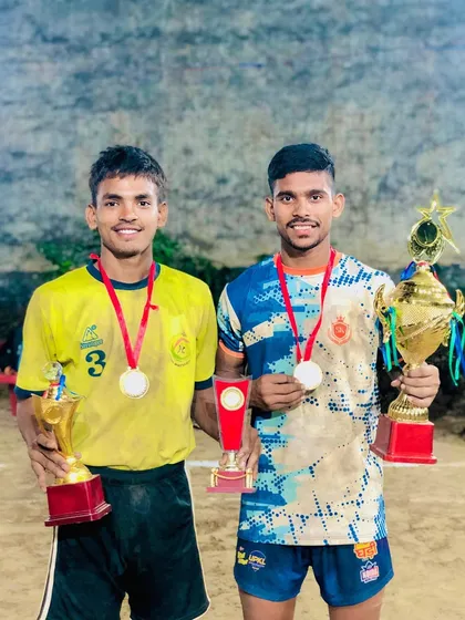 Two of our top players holding their individual and team trophies after a big win.