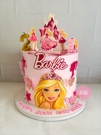 A dreamy Barbie cake with a castle topper and beautiful butterfly accents.