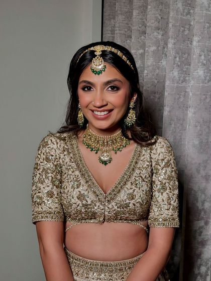 A close-up portrait. The makeup is perfectly balanced, with defined eyes and a natural skin finish.