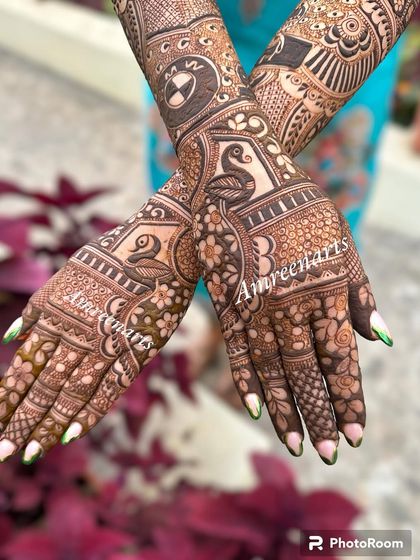 The back of the hands from a personalized bridal set, featuring swans and a BMW logo.