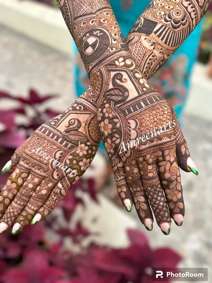The back of the hands from a personalized bridal set, featuring swans and a BMW logo.