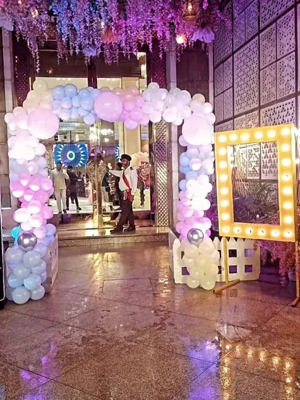 The entrance setup for a Cocomelon themed party. I created a pastel balloon arch and a light-up photo frame to welcome guests and provide a great spot for pictures.