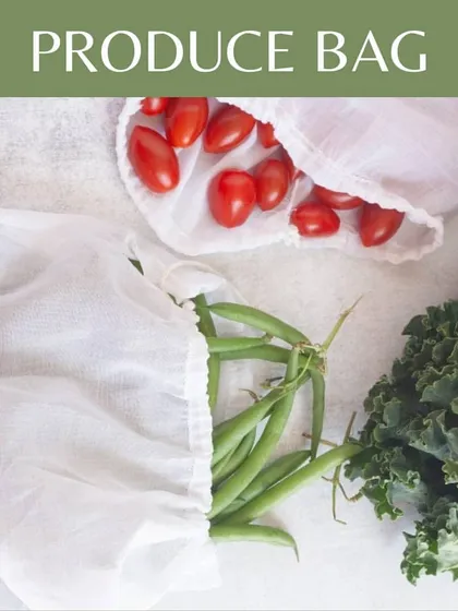 Keep your vegetables fresh and plastic-free with our reusable cotton produce bags. This overhead shot shows the bags in action, holding fresh cherry tomatoes and green beans, demonstrating a practical alternative to single-use plastic at the grocery store.