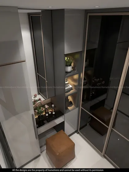 A spacious master bedroom wardrobe with a built-in vanity. The smoked glass doors and integrated lighting create a luxurious and functional dressing area.