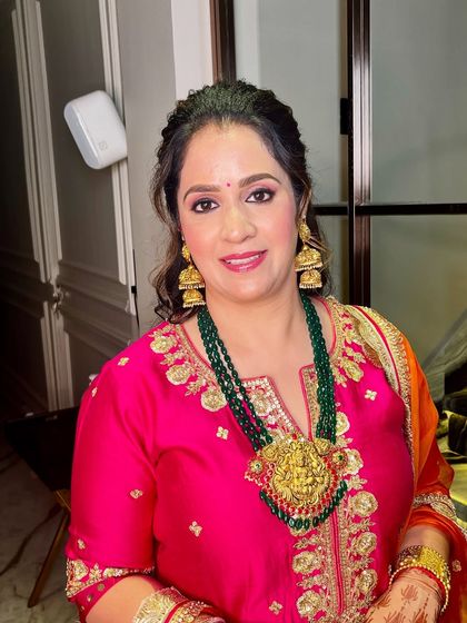 A smiling portrait, showing how the makeup brightens her face and enhances her features.