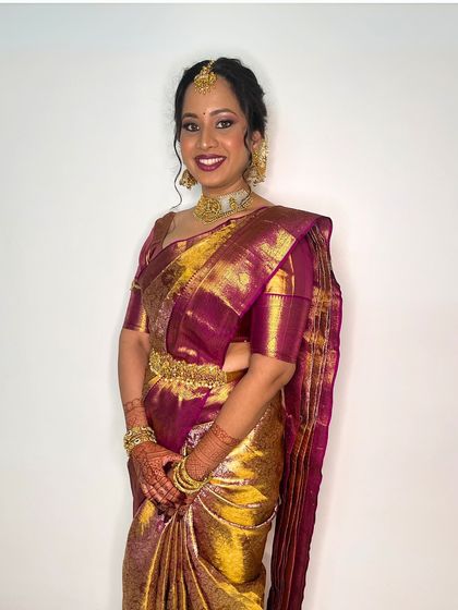 A classic and elegant bridal portrait. The makeup is flawless, with a focus on creating a smooth, radiant complexion that glows from within.